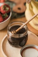 honey in jar with wood dipper